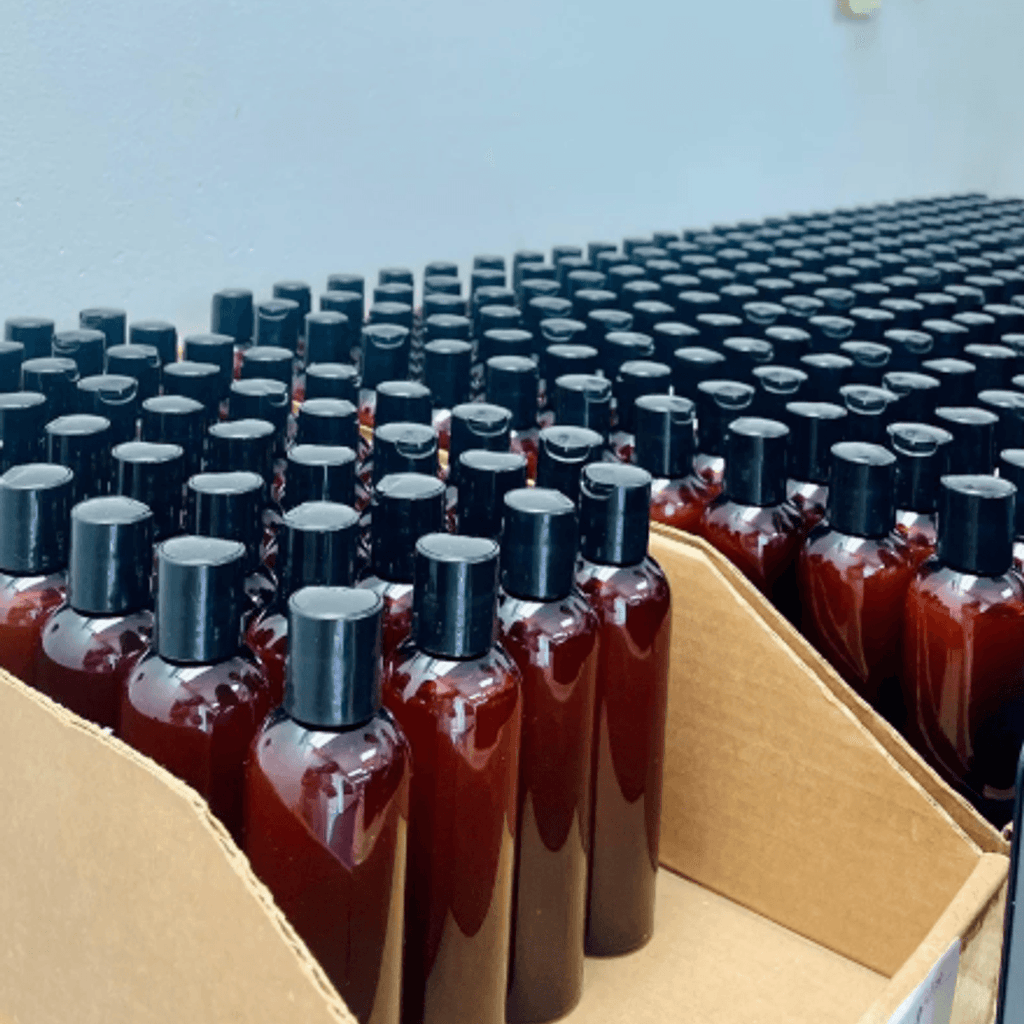Full body glow kit bottles in bulk — amber bottles ready for dispatch