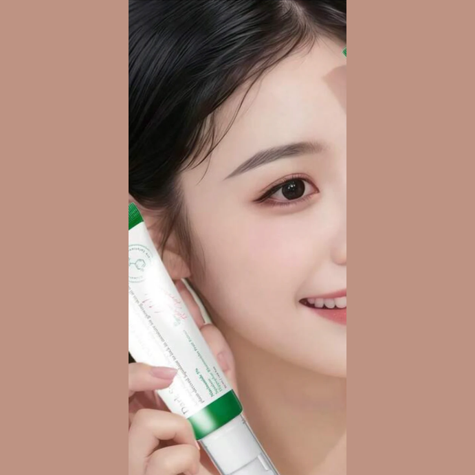 AXIS-Y Dark Spot Correcting Glow Serum tube held near face showing green cap and label
